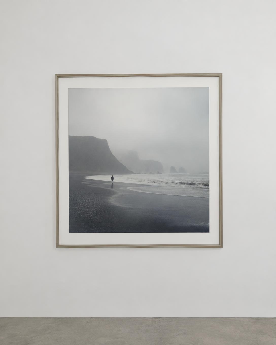 Framed fine art photograph of a misty coastline in a gallery